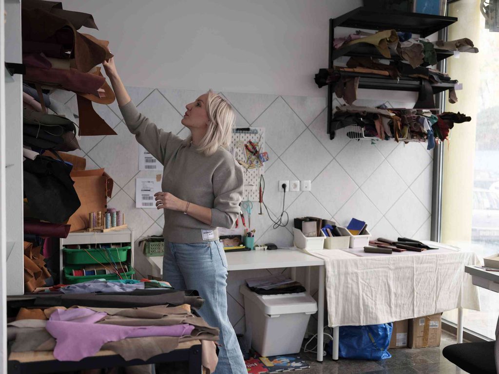 Girl pulling out the leather from the shelf